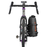 Bicycle with a black bag attached to the fork on a white background