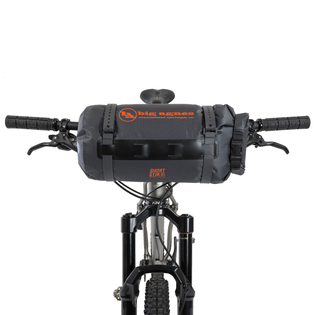 Bicycle handlebar with a black bag and visible branding on a white background