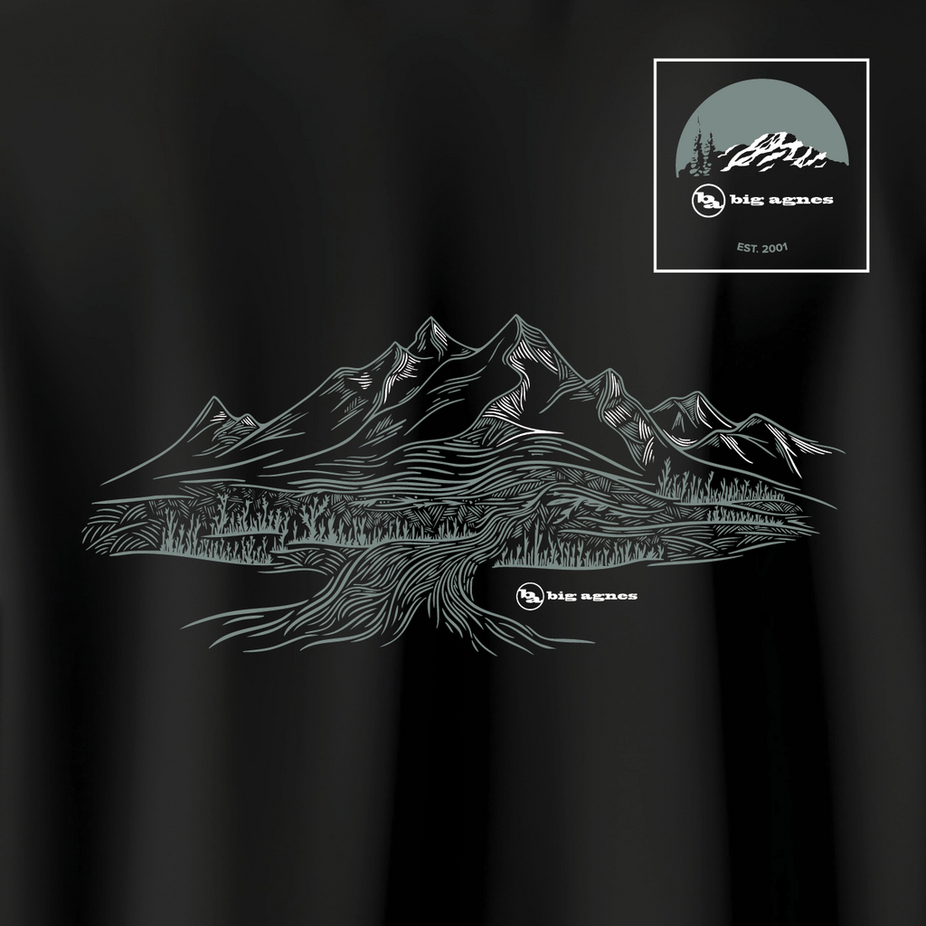 Black t-shirt with mountain design and 'Big Agnes Returns' logo on a dark background
