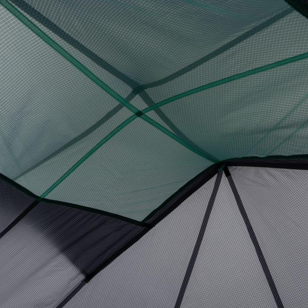 Close-up of overlapping mesh and Hyperbead fabric panels on the Big Agnes Returns Pitchpine VST 1.5, with intersecting seams and geometric shapes in green and gray—showcasing this innovative ultralight shelter design.