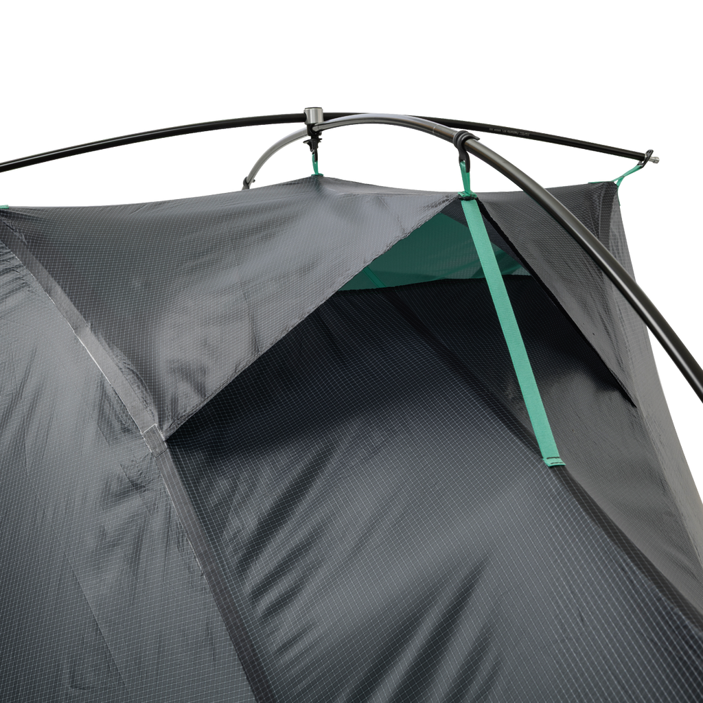 A close-up of the upper section of the Big Agnes Pitchpine VST 1.5 tent, highlighting its Hyperbead fabric texture, green support poles, and a vent with green trim, set against a plain white background.