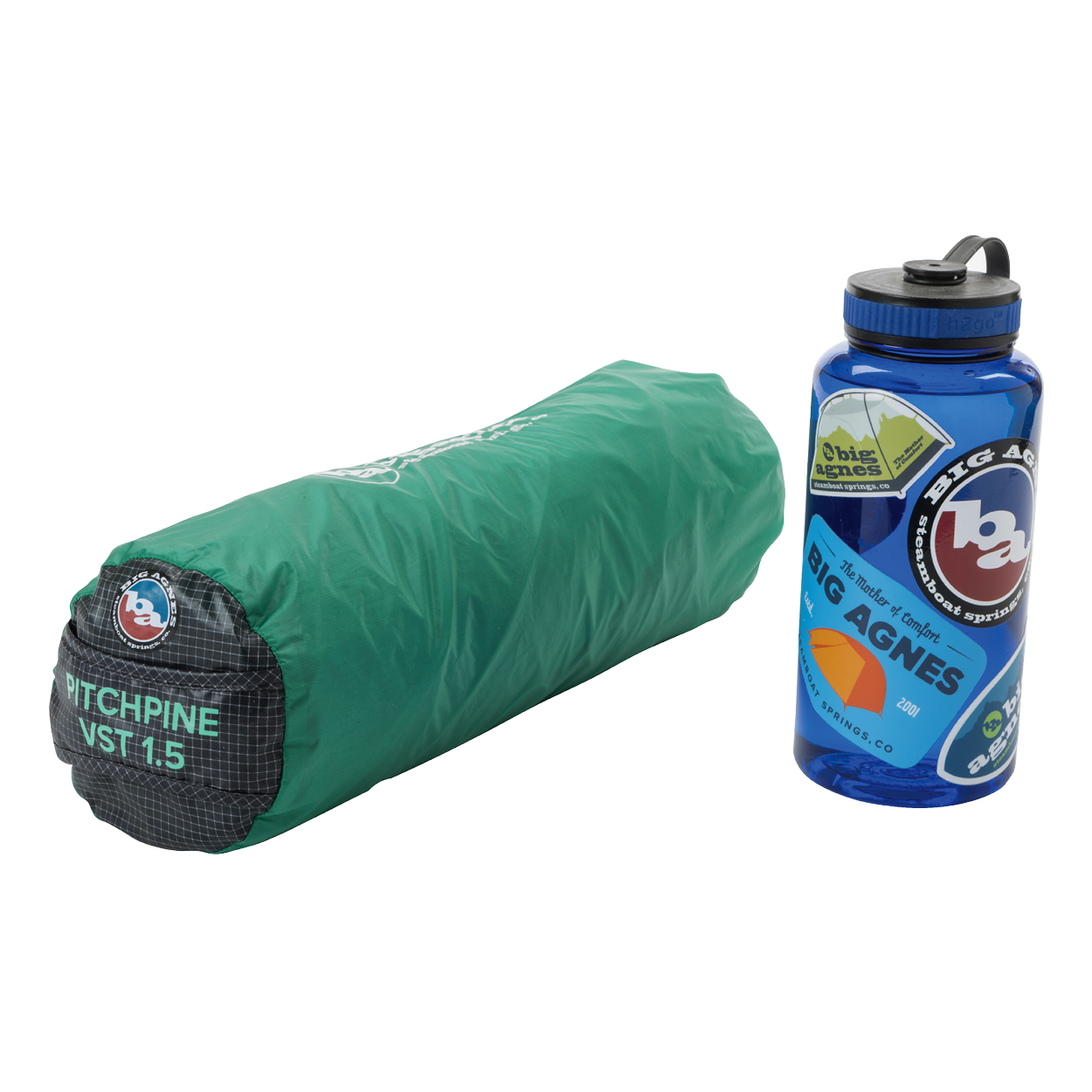 A rolled-up green Big Agnes Returns Pitchpine VST 1.5 ultralight shelter sits next to a blue water bottle decorated with Big Agnes Returns stickers.