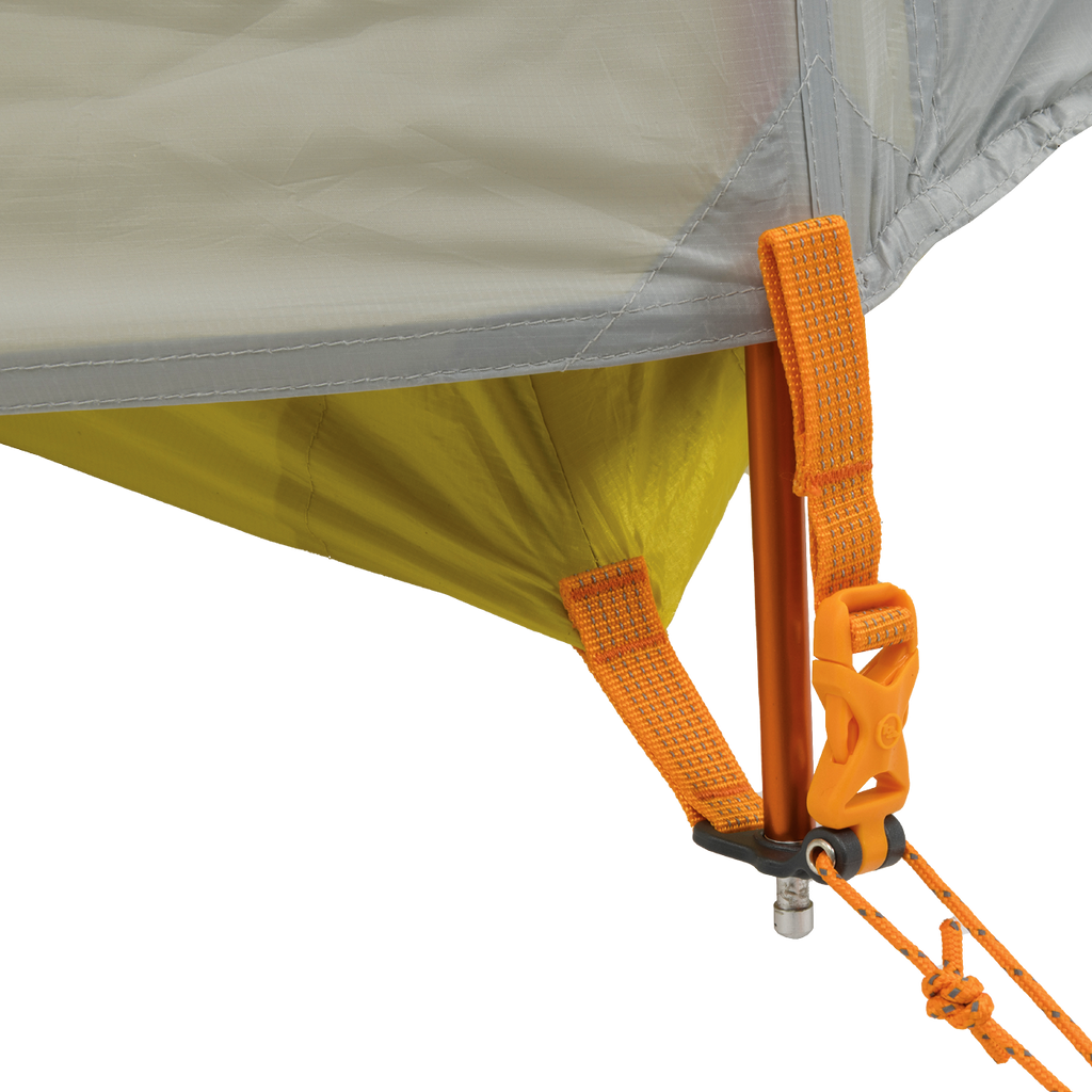 Close-up of the Big Agnes Returns Salt Creek 2 tent corner reveals orange straps, yellow fabric, and an orange pole secured by a metal pin, clip, and guyline—perfect for campers seeking durable gear with panoramic views.