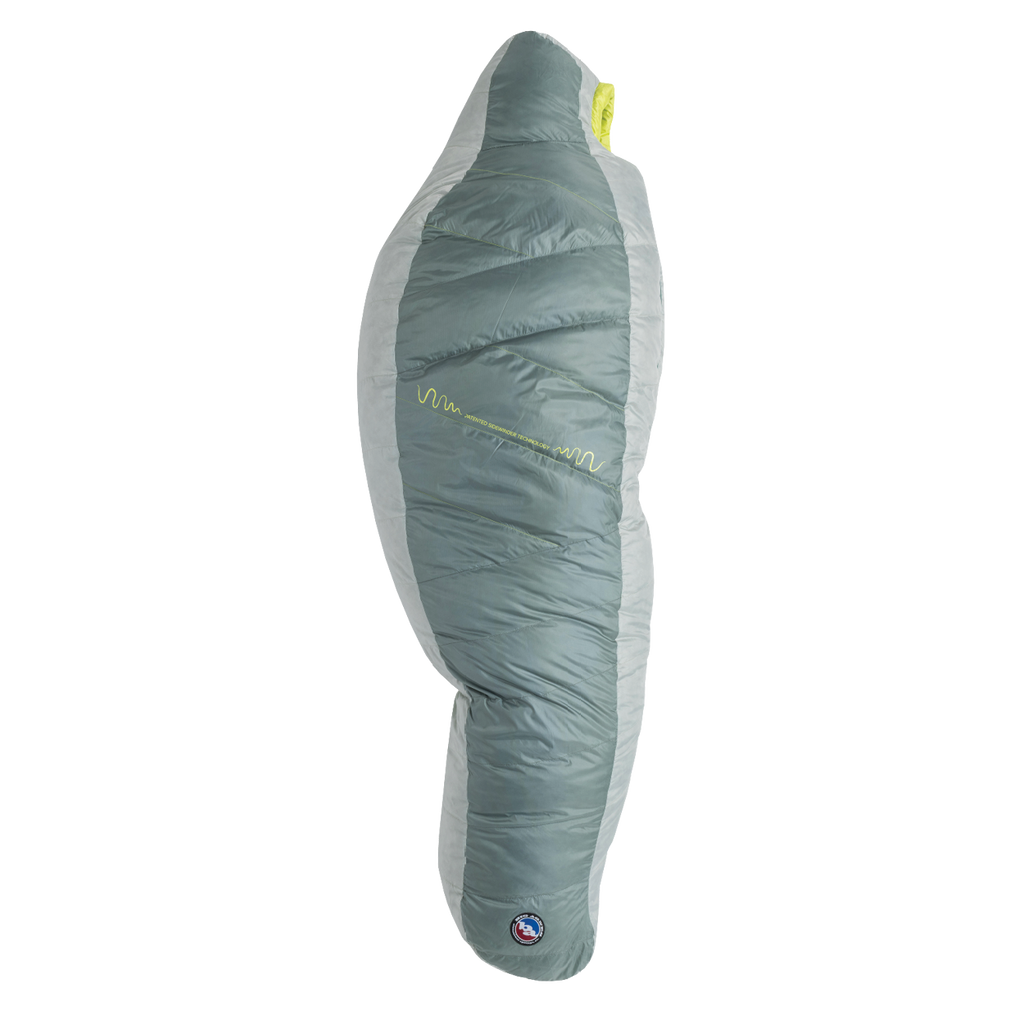 The Big Agnes Sidewinder 0˚, a grey and light green mummy-style sleeping bag, stands upright on a white background, showcasing its tapered shape, quilted design, body mapped insulation, and a small logo near the bottom.