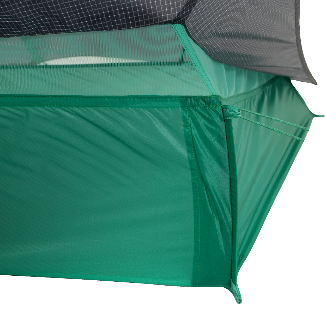 Close-up of the corner of the Big Agnes Returns String Ridge VST 1.5 tent, an ultralight shelter featuring mesh upper panels, solid green lower fabric, and precise stitching that showcases its quality construction.