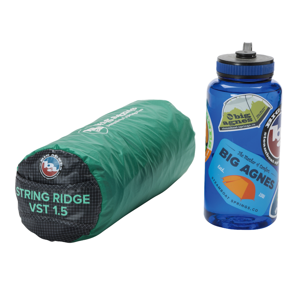 A green, rolled-up Big Agnes Returns String Ridge VST 1.5 ultralight shelter sits next to a blue Nalgene water bottle decorated with outdoor-themed stickers.