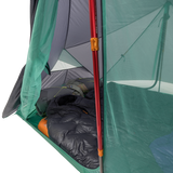 Camping tent with a sleeping bag inside, showing the interior setup.