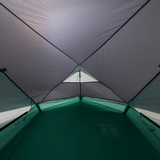 Inside view of a tent with green floor and gray walls