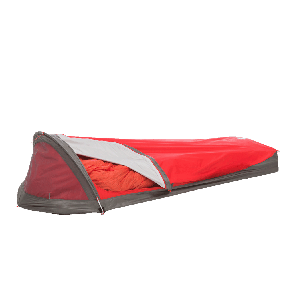 A red and gray Big Agnes Three Wire Hooped Bivy sits with its side partly open, displaying an orange sleeping bag inside. The low-profile, one-person bivy offers four-season protection and is shown against a plain white background.