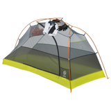 Tiger Wall UL1 Bikepack camping tent with a white shirt, black pants, and red shoes hanging inside on a white background