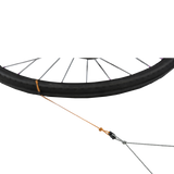 Bicycle wheel with a cable and housing on a white background